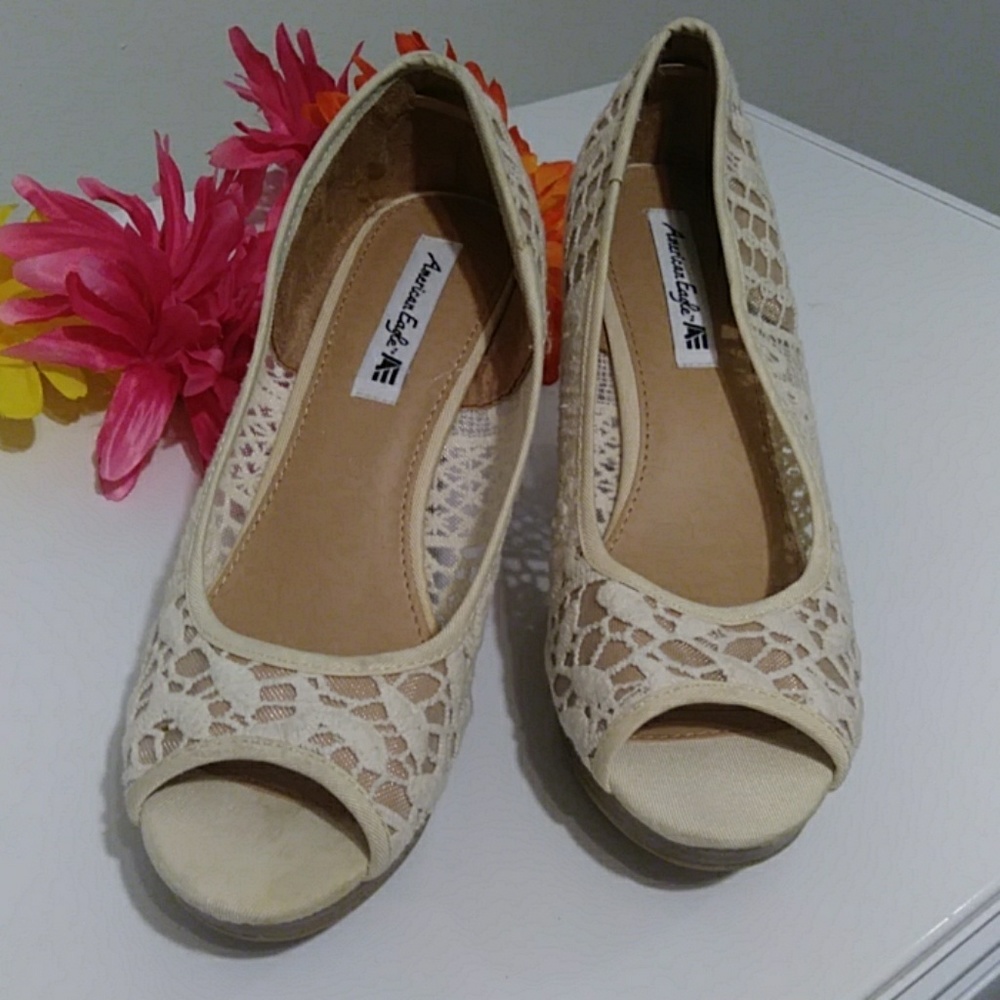 Cotton, wedge heel open toe shoe w/open designs.